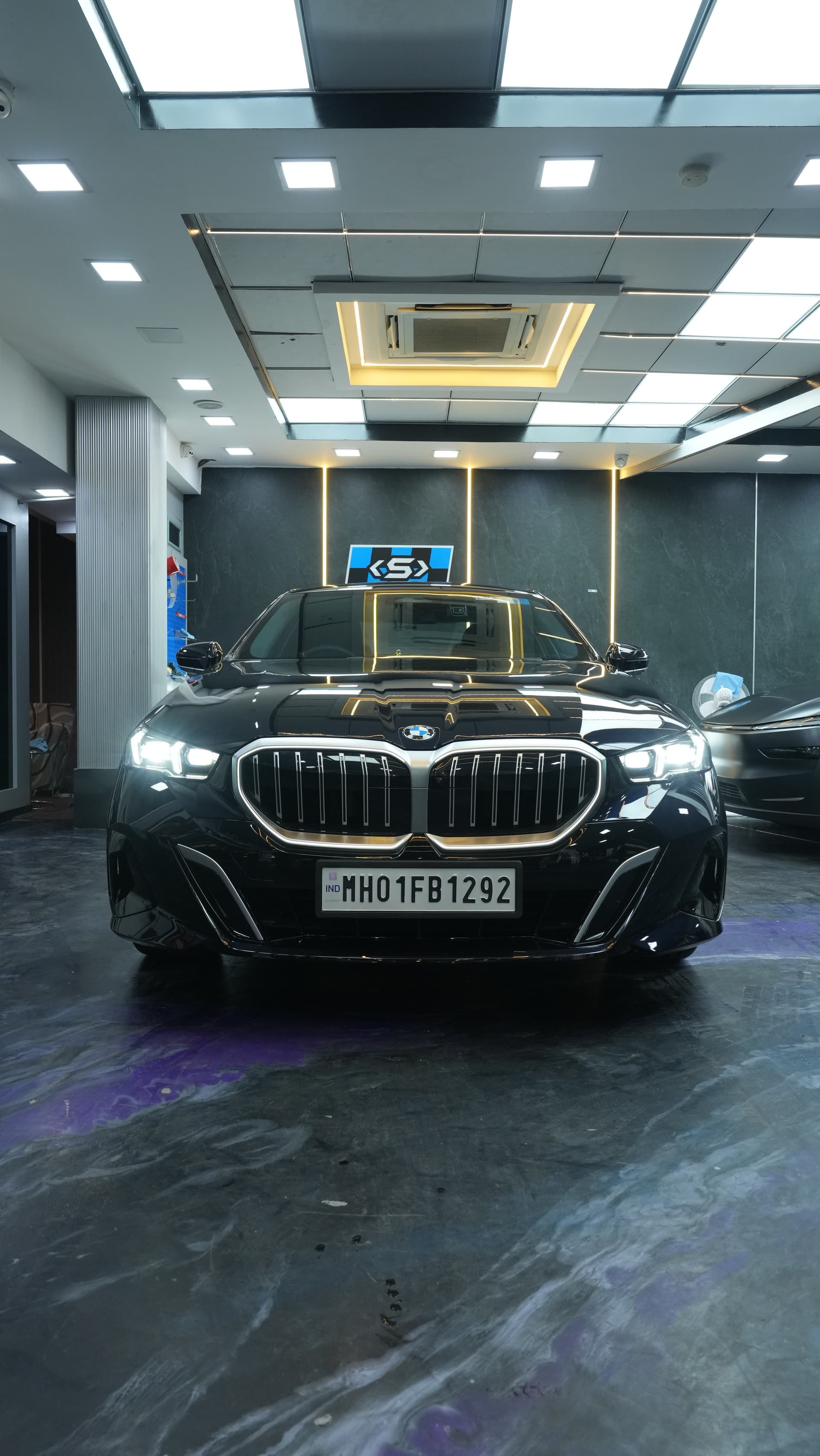 Black BMW sedan after full-body paint protection film installation at Carsuit Worli studio