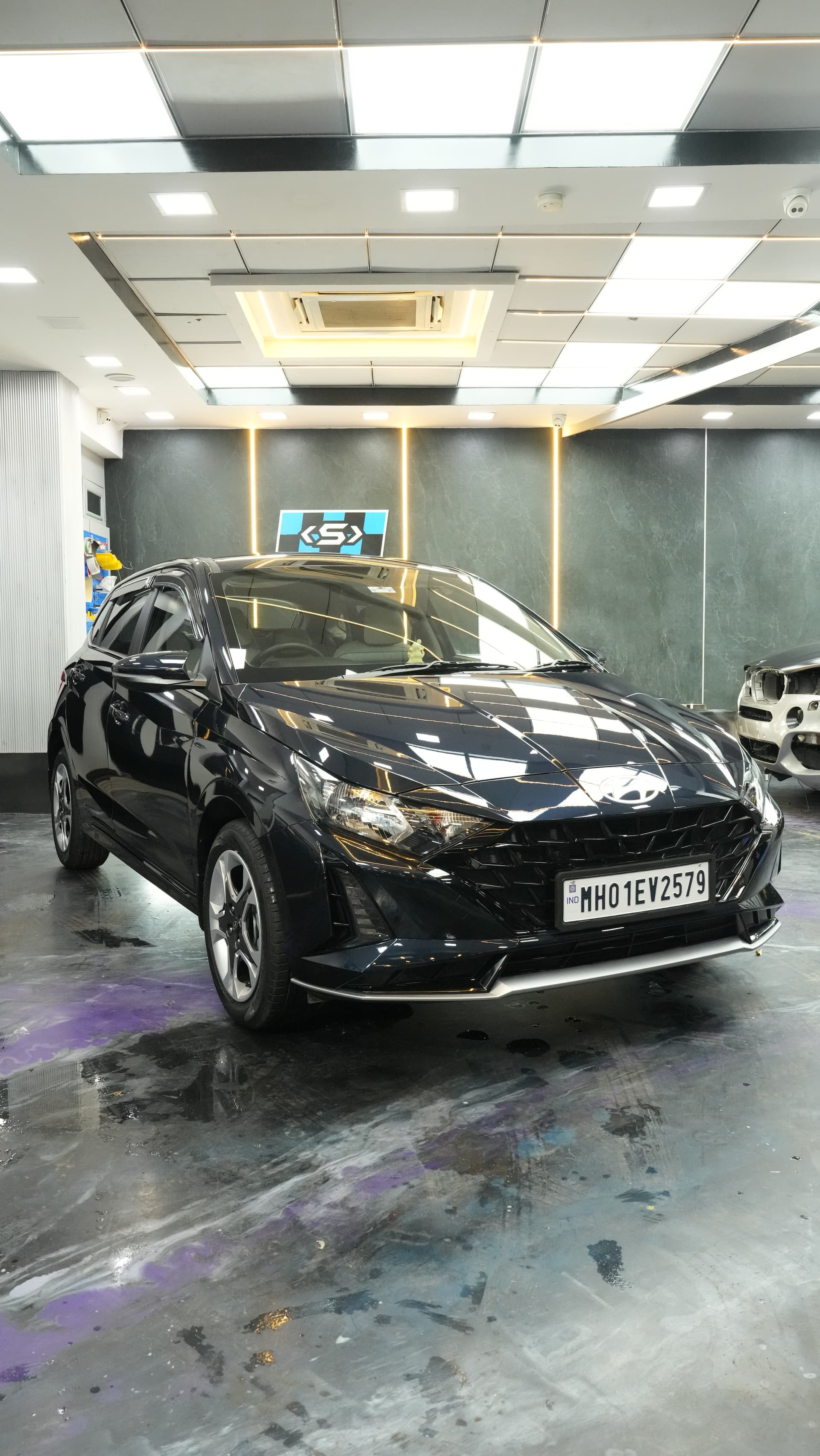 Freshly painted car curing under studio lights at Carsuit Mumbai